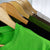 Tree hugger shirt on a wooden hanger close-up showing detailed stitching and collar, in front of 4 other eco-friendly shirts.