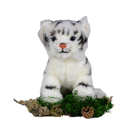 white realistic tiger plush toy, placed on patch of green moss with a pinecone in front of it's paws.