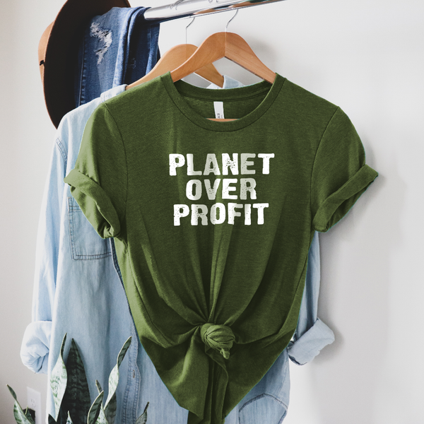 Planet Over Profit Save the Planet Shirt on a wooden hanger on a rack with a brown hat and blue jean jacket